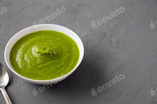 Preview: Homemade Organic Broccoli Soup on gray surface, side view. Space for text.