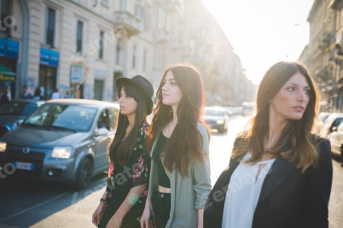 Preview: Three young women strolling in city