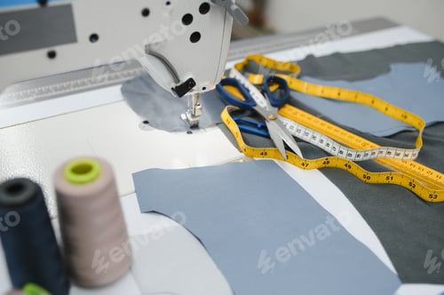 Preview: Composition of sewing thread, scissors and tape measure on a white table. C