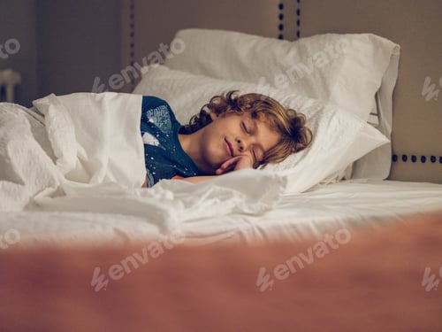 Preview: Boy sleeping on bed in daytime
