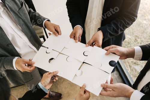 Preview: The concept of teamwork and partnership. Businessman's hands putting together puzzle pieces