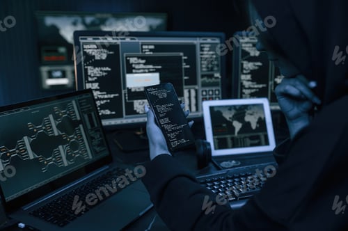Preview: Young professional female hacker is indoors by computer with lot of information on displays