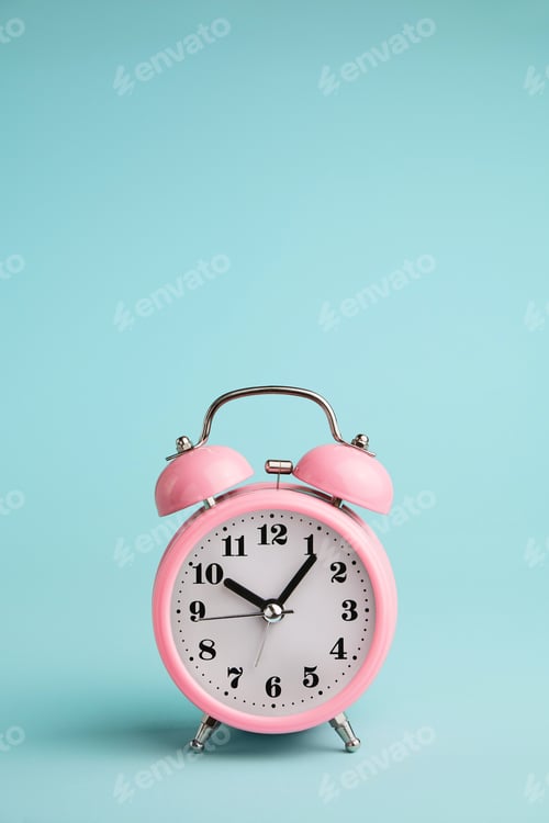 Preview: Pink alarm clock on blue background