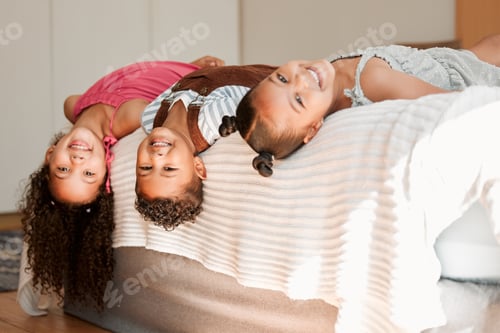 Preview: Fun, playful and silly generation of kids lying on a bed with cute hairstyle and smiling portrait.