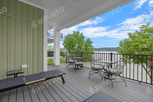 Preview: an outside balcony with a table and chairs and mountains in the background