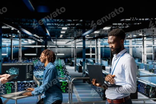 Preview: African american smiling engineer in data center monitoring neural network