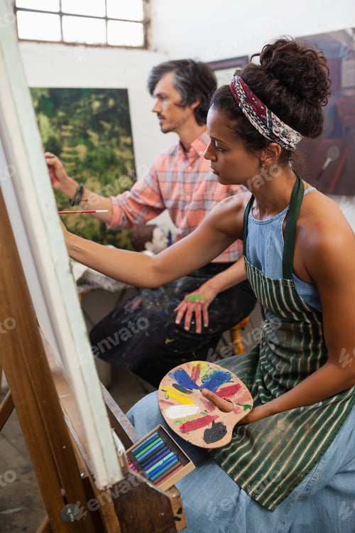 Preview: Man and woman painting on canvas