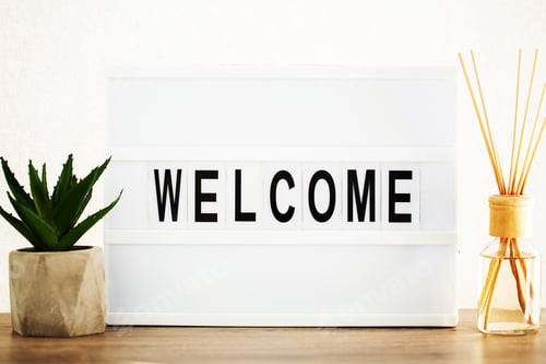 Preview: Led letter board with welcome word on table.