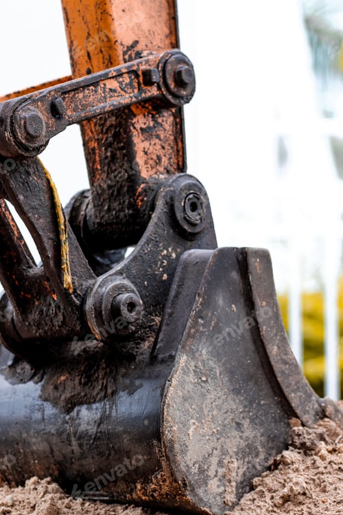 Preview: Vertical shot of excavator bucket in the ground