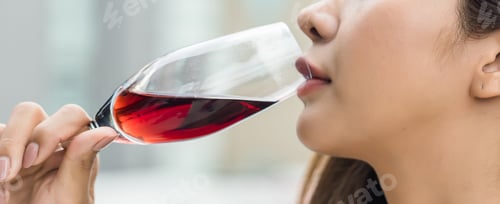 Preview: Attractive woman drinking wine from wine glass. wine in a classic glass. Beautiful young woman drink