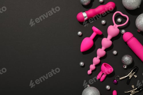 Preview: Sex toys with Christmas decorations on a dark background.