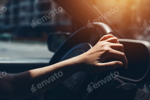 Preview: Female hand on car steering wheel