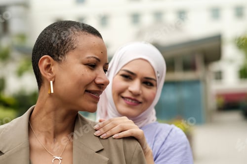 Preview: Female friends of different cultures posing together.