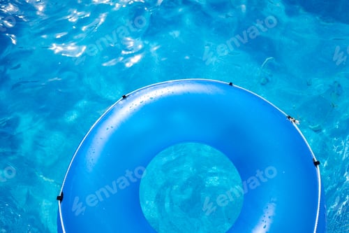 Preview: Inflatable plastic ring floating above a pool on a hot summer day.