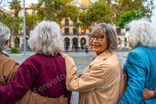 Preview: Group of senior friends walking in city looking back