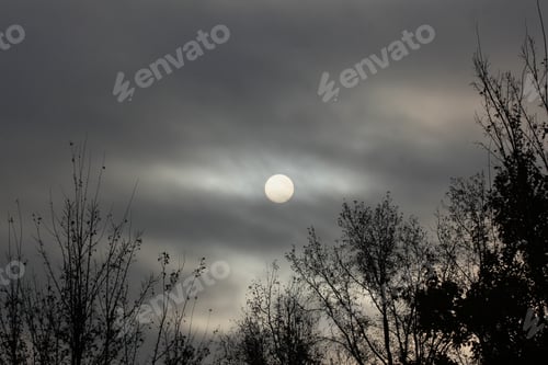 Preview: Morning Sun Through Clouds - Photograph Of An Eerie And Dramatic Morning Sun Low On The Horizon And