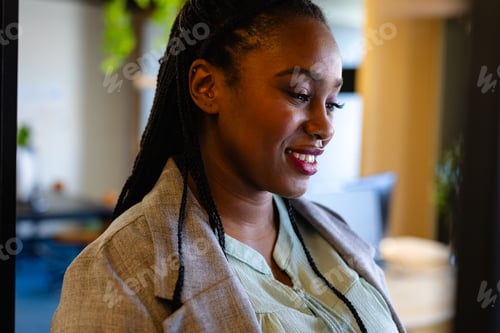 Preview: Happy plus size african american casual businesswoman in office