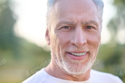 Preview: A picture of a gray-haired man looking confident
