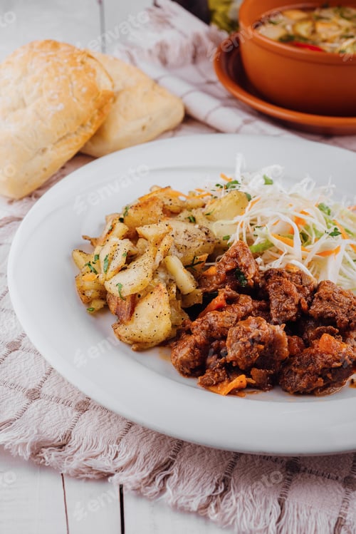 Preview: Delicious beef stew served with roasted potatoes and fresh coleslaw salad