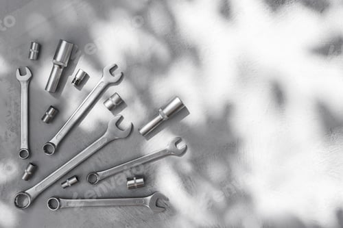 Preview: Metal tools on a gray concrete table top view.