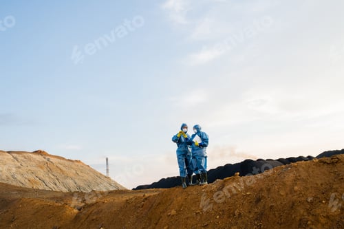 Preview: Small figures of female researchers standing on top of hill during investigation