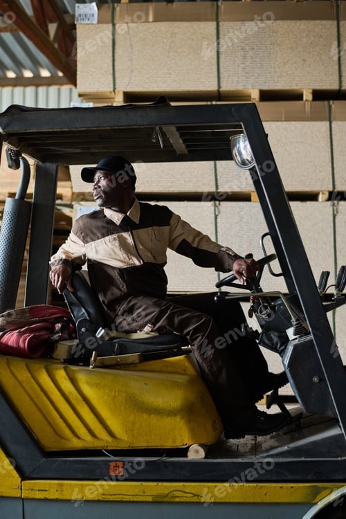 Preview: Forklift driver working in industrial factory