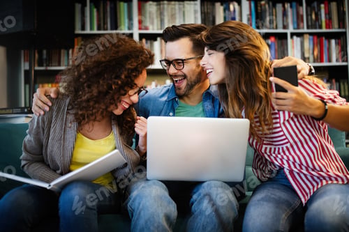 Preview: University students in cooperation at library. Group of young friends reading books