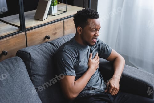 Preview: stressed african american man having heart attack at home