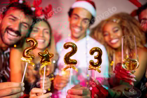 Visualização: Amigos segurando pequenos balões em forma de números 2023 na contagem regressiva da meia-noite da festa de Ano Novo