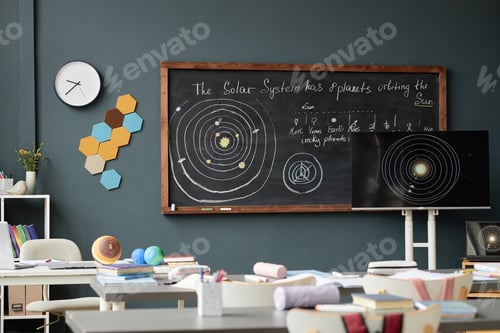 Preview: Empty Classroom Displaying Solar System Diagram on Blackboard and Monitor