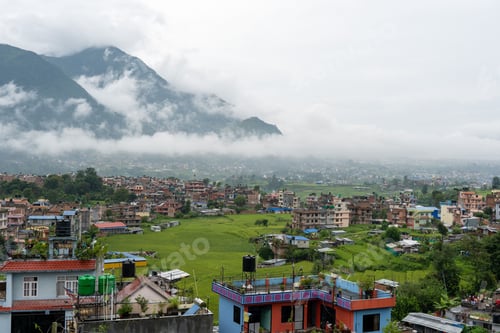 Preview: Aerial view of the village against the mountains on a gloomy day