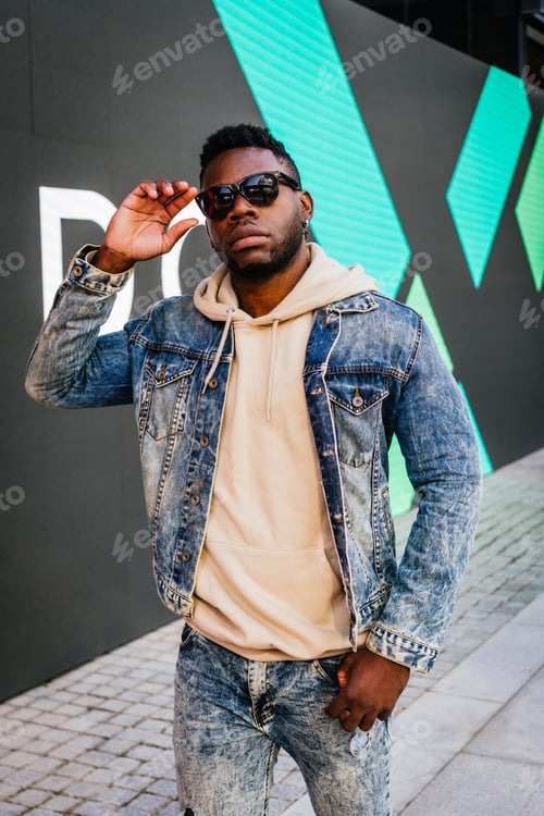 Preview: Black man posing glasses against a black background