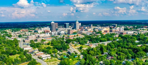 Preview: Aerial shot of the skyline of Greensboro located in North Carolina, USA, on a partly cloudy day