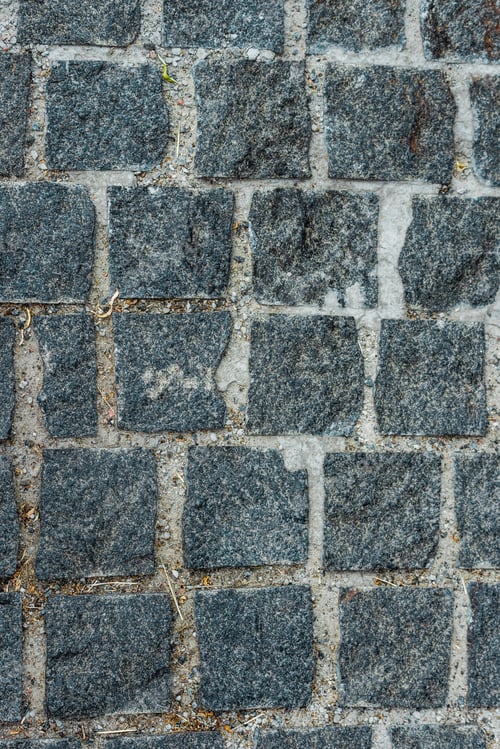 Preview: top view of black paving stones on road in city