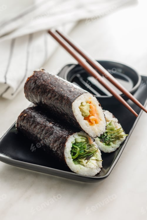 Preview: Sushi rolls on Plate with bowl of soy sauce and chopsticks.