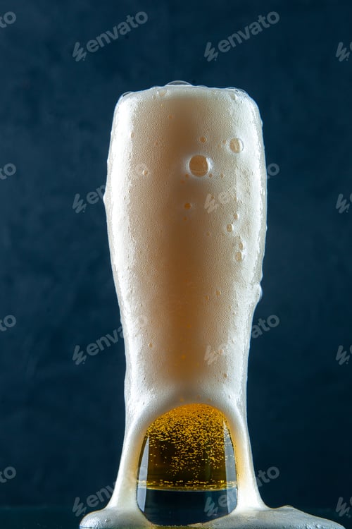 Preview: Close up view of filled glass of beer on dark blue background in vertical view