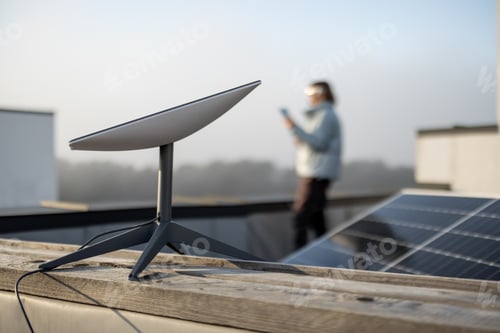 Preview: Starlink satellite dish on roof of residential building and woman on background