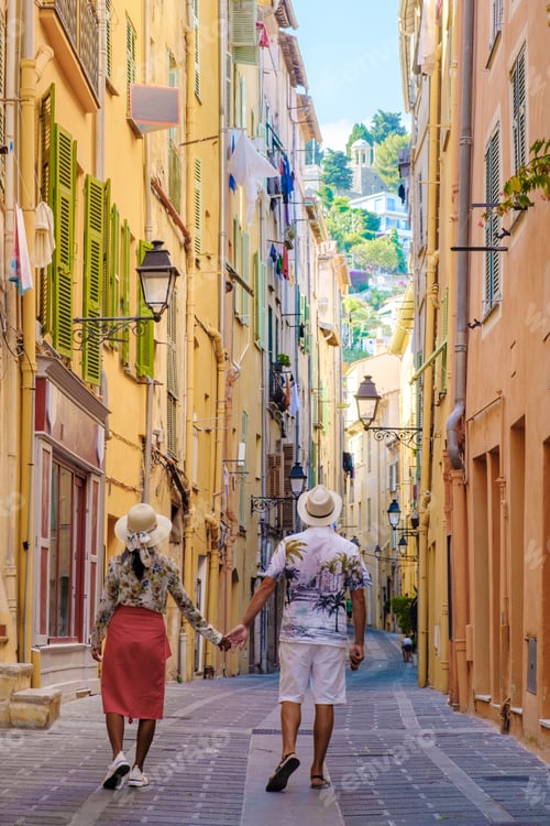 Preview: Menton France,couple men and woman on vacation at the Cote d Azur France, View on old part of Menton