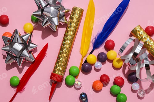 Preview: Candies, feathers and candles on pink background, top view