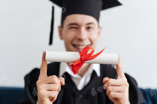 Preview: Caucasian young man feeling very excited to receive his bachelors degree