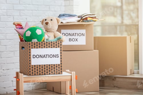 Preview: Donation boxes with toys and clothes indoors