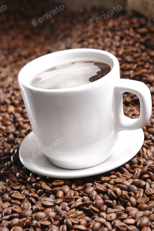 Preview: Vertical shot of fresh espresso cup on background of coffee beans