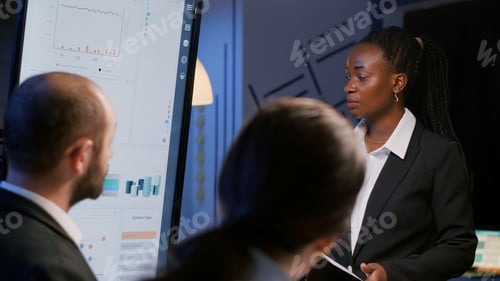 Preview: African american businesswoman brainstorming financial strategy working overtime