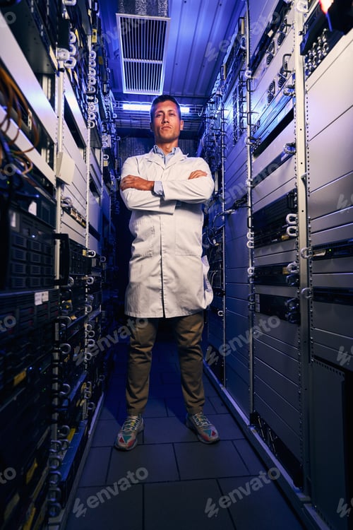 Preview: Serene IT technician standing alone in server room