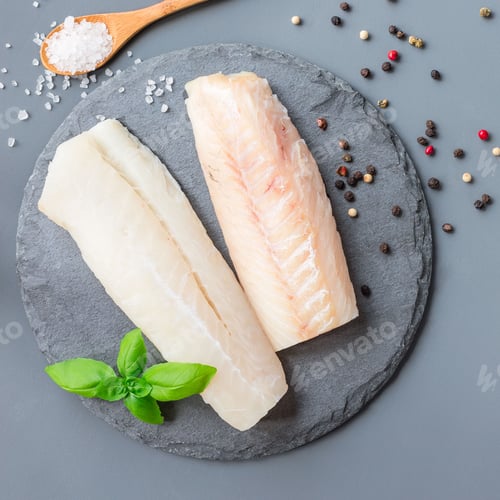 Preview: Fresh raw cod fillet with spices, pepper, salt, basil on a stone