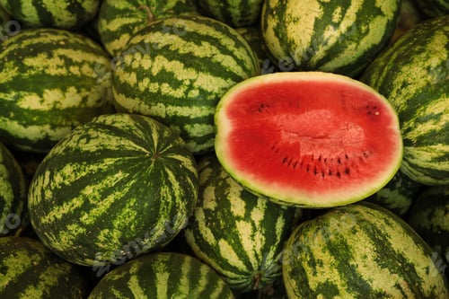 Preview: Delicious whole and cut watermelons as background, above view