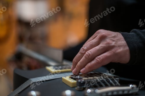 Preview: Black electrical guitar in repair service shop