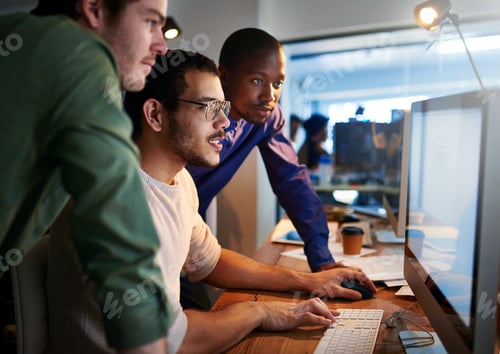 Preview: Shot of a team of young businesspeople working late in the office