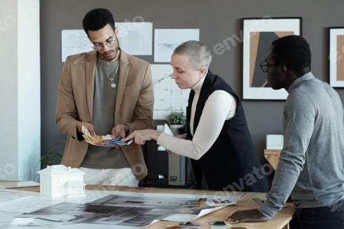 Preview: Three colleagues choosing colors for apartment interior from palette