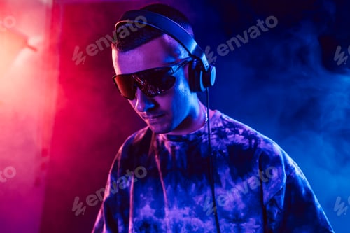 Preview: Club DJ playing music at party wearing sunglasses